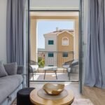 exit to the balcony from living room with grey curtains