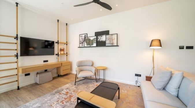 dnevna soba sa neobicnom policom za tv i klub stolom